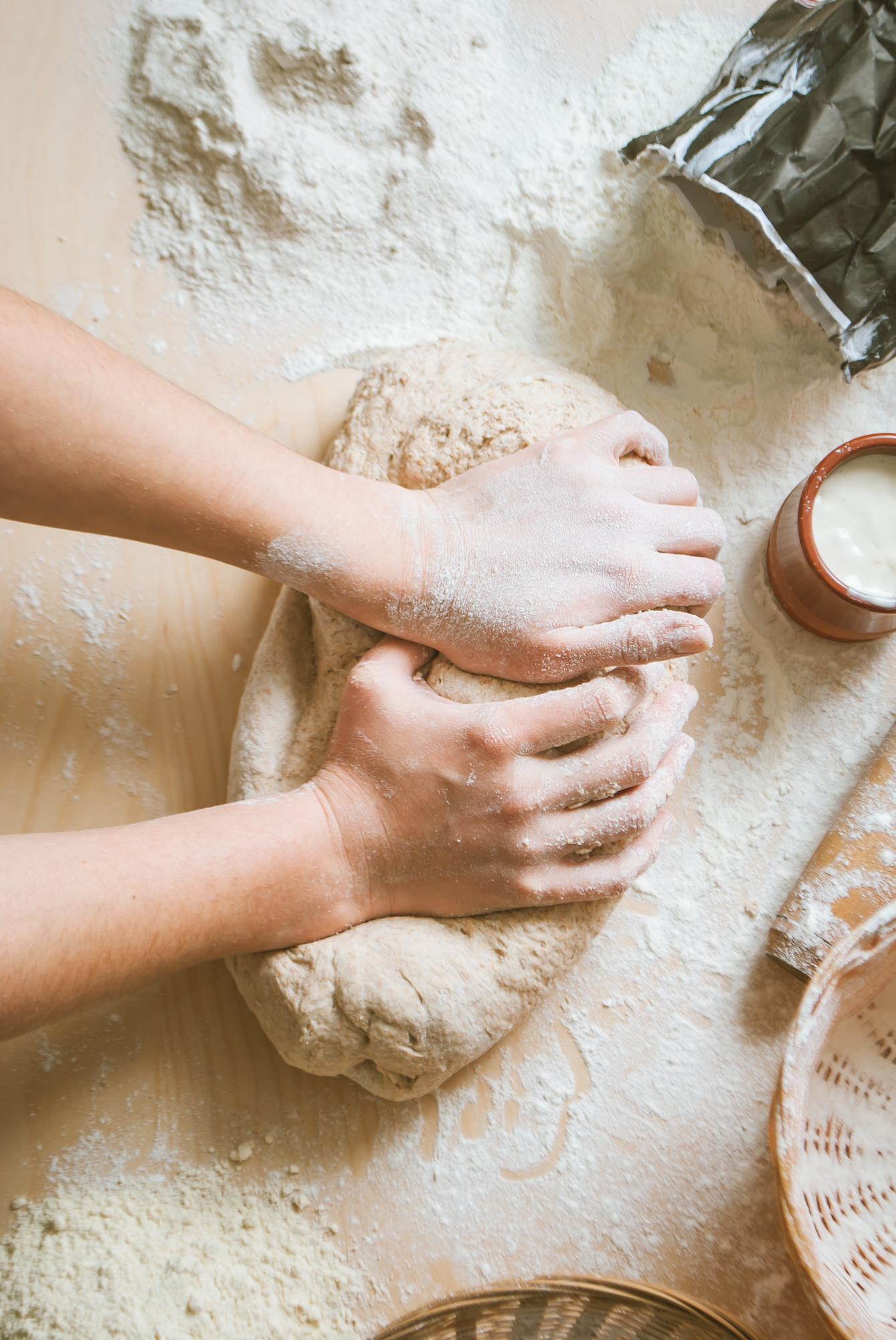 Hands kneading dough in workshop